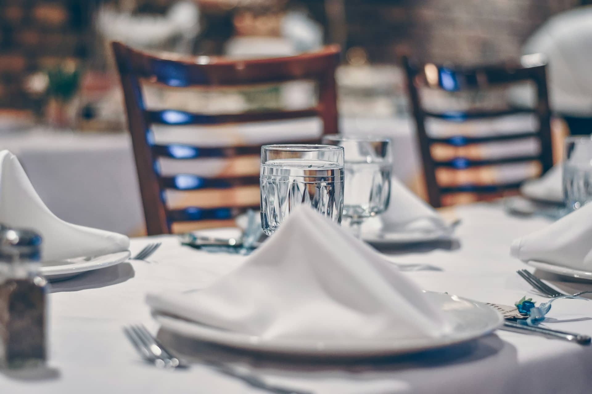 A table laid with linen and glassware